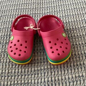 Pink crocs with colorful stripes